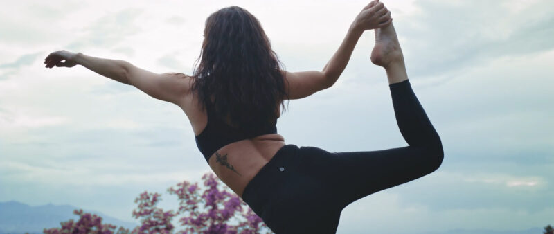 A woman doing the Dancer pose to improve balance